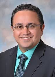 Dr. Anish Nihalani in a suit and tie.